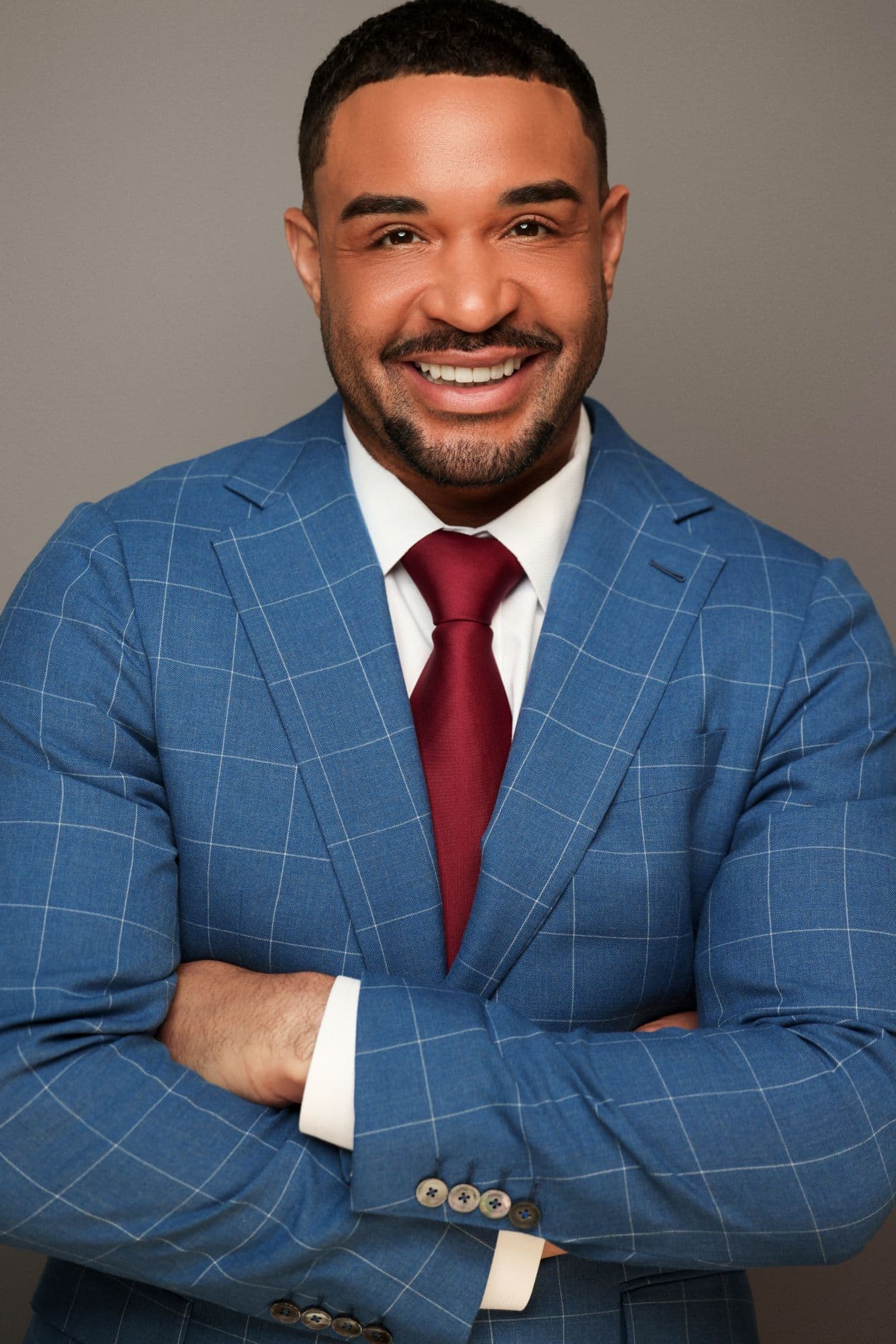 Jordan Dziabiak, board certified life coach, smiling in a blue suit